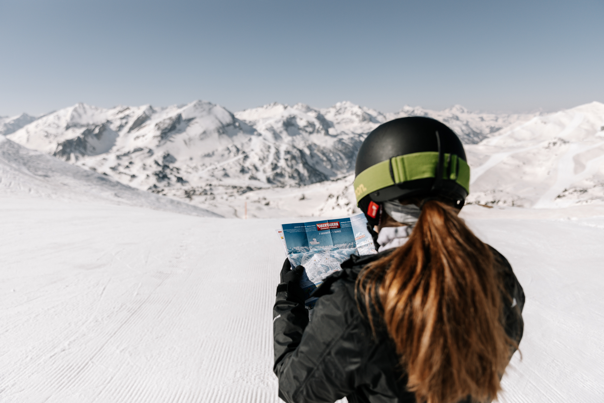 Skifahrer der eine Karte liest mit Bergpanorama
